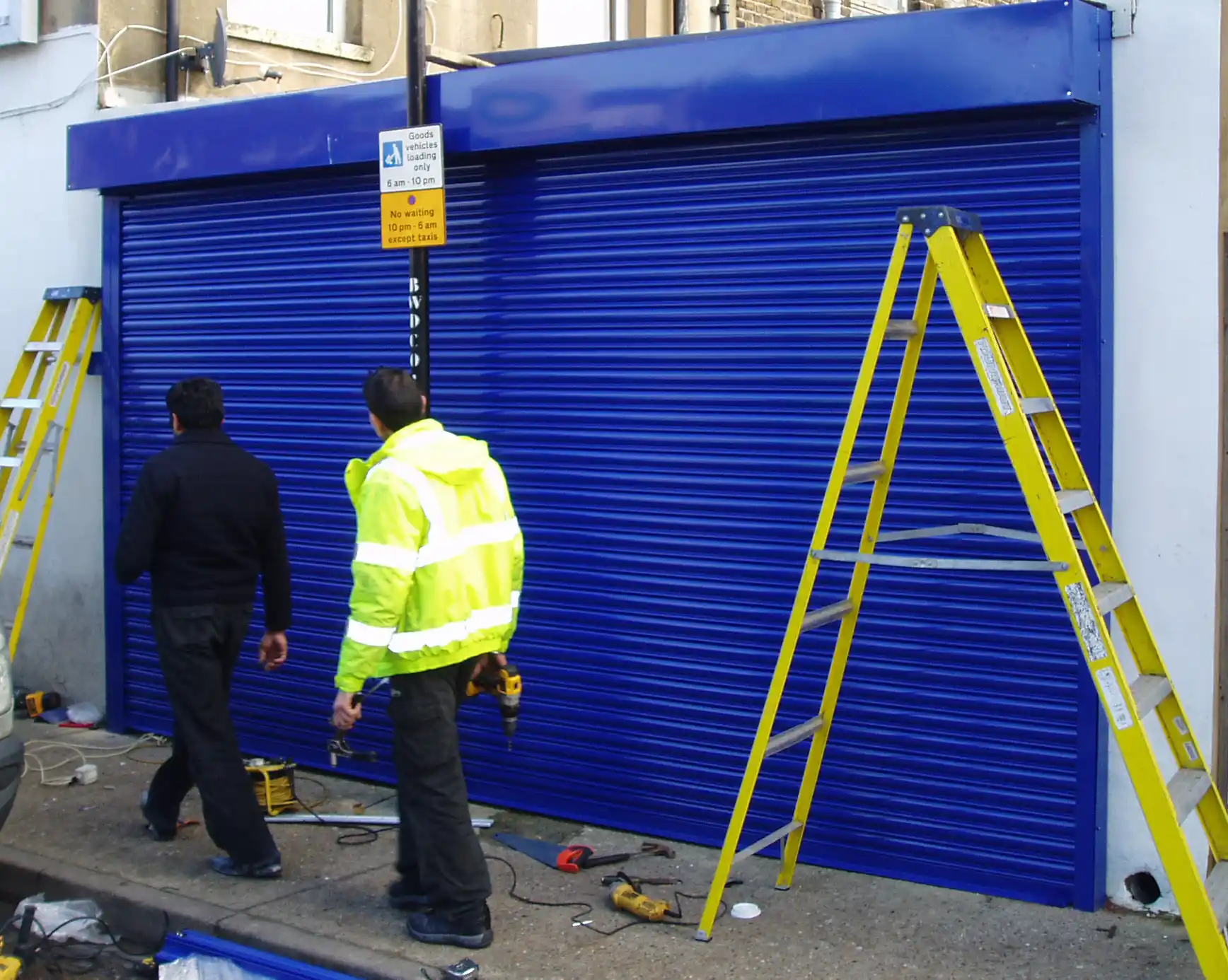 Professional technician repairing a commercial roller shutter in City Of London